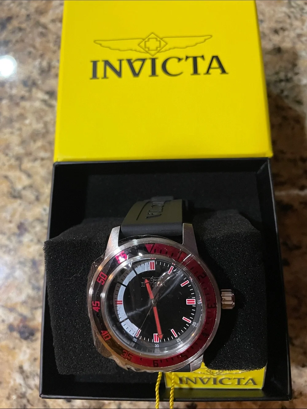 Invicta Black Dial Watch with Red Accent Bezel